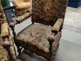 pair of antique upholstered chairs in a room with a blue couch
