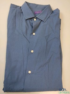 a blue shirt with white dots on it sitting on a table