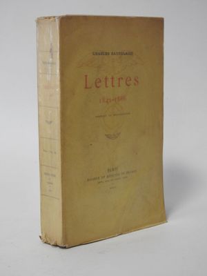 an old book sitting on top of a table next to a white wall
