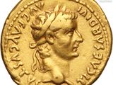 a gold coin with a woman ' s head and a crown on it