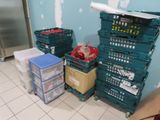 many crates that are sitting on the floor in the kitchen