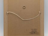 a cardboard box with a string wrapped around it and a ring on it