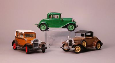 three toy cars that are sitting on top of each other