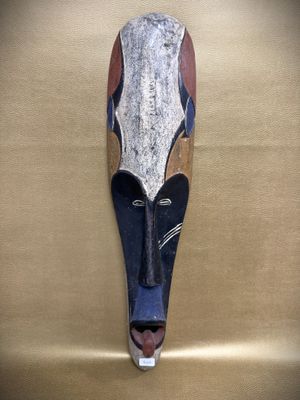 an image of a wooden mask on a wall