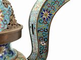 a blue and gold vase with a bird on it