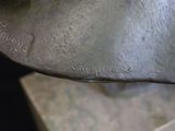 a close up of a bronze statue of a man ' s head