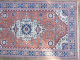 an orange and blue rug with a medallion design on it