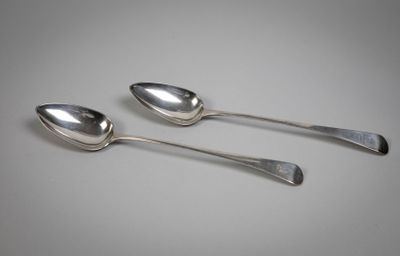 three silver spoons sitting on top of each other on a table