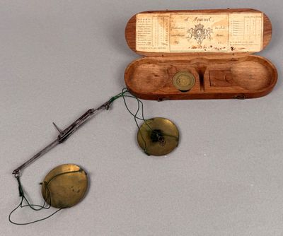 a wooden case with a pair of glasses and a pair of eyeglasses