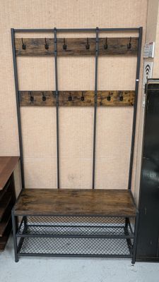 a wooden bench and a metal rack in a room