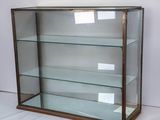 a display case with glass shelves in it on a white surface