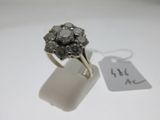 an image of a silver ring with a cluster of gray diamonds
