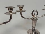 a silver candelab with three candles on it