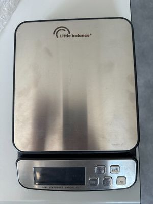 a silver electronic scale on a white counter top
