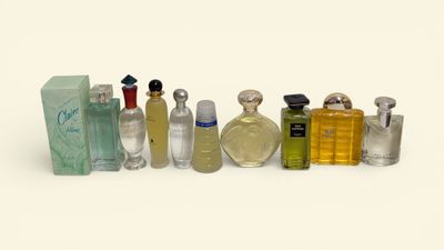 many different types of perfume bottles lined up on a white surface
