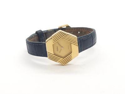 a close up of a watch on a white surface