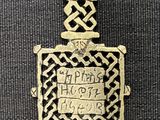 a gold bracelet that has a celtic design on it