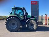 a tractor that is parked in front of a building