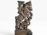 a statue of a man riding a horse with a bird on his back