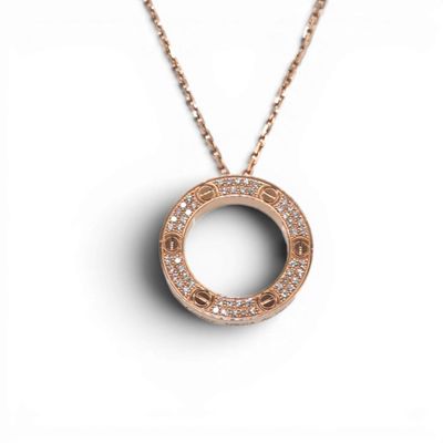 a rose gold necklace with a circular pendant with diamonds on a chain