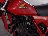 a red motorcycle that is parked in a garage