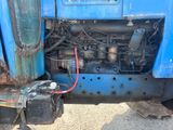 a blue truck with a red hose attached to the front of it