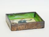 a small metal tray with a picture of a horse on it
