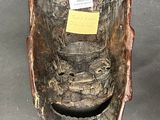 a wooden toilet that has a sticker on it