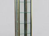 a glass and brass display case with glass shelves