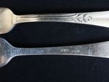 two spoons that are sitting next to each other