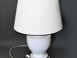 a white lamp with a brown shade on it