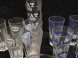 a lot of glasses sitting on a table with a black background