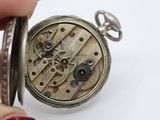 a close up of a pocket watch being held by a person