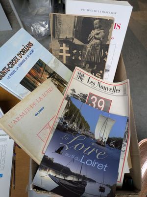 a lot of books in a box on the floor