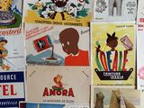 many different types of advertising posters on the wall