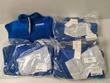 four pairs of blue sweaters are wrapped in plastic bags