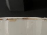 a close up of a white bowl with red and blue designs on it
