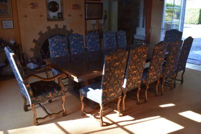 a large dining room table and chairs in the sun