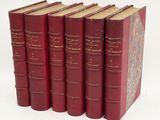 six red books are lined up in a row on a white surface