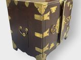 a brown and gold chest sitting on top of a table