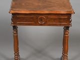 an old wooden table with a drawer on top of it