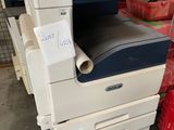a printer that is sitting on top of a pile of boxes