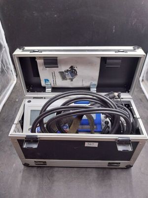 a metal case with a hose in it on the floor