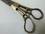 a pair of scissors sitting on a white surface