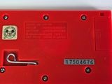 a close up of a red device on a white surface