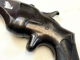 a gun that is laying on a white surface