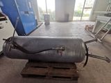 a large metal tank sitting on a pallet in a room