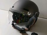 a helmet that has been smashed and is sitting on the floor