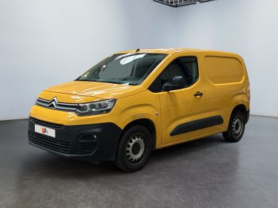 a yellow van parked in a white room with a black floor