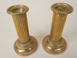 pair of antique brass candlesticks on a white background